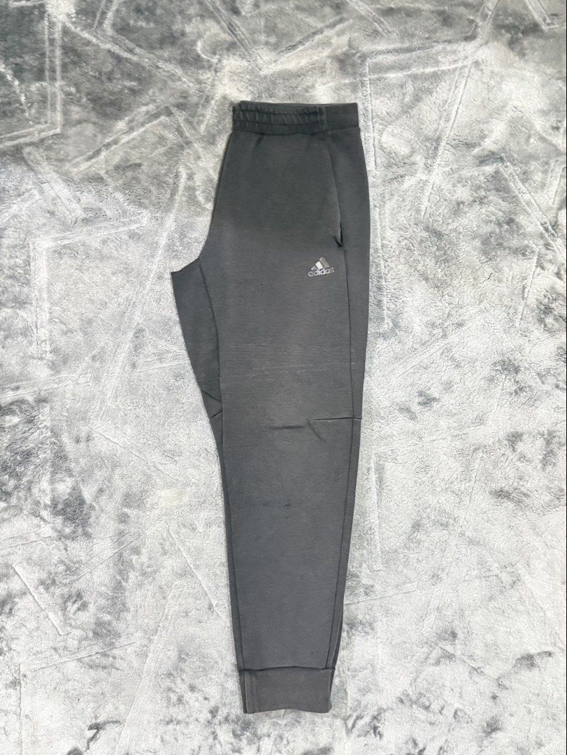 Adidas Grey Joggers Sweatpants Cuffed Ankle (Category: Joggers) located in Tagaytay City. Submitted by belletrendss (Listing ID 1465650585, Image 2). Description: - Brand: Adidas - Color: Grey - Features: Elastic waistband, ribbed cuffs, convenient side pockets, and black Adidas logo print - Condition: Minor fabric wear with tiny holes on the left leg near the knee - Best for: Lounging at home or casual workouts - PM for measurements or questions