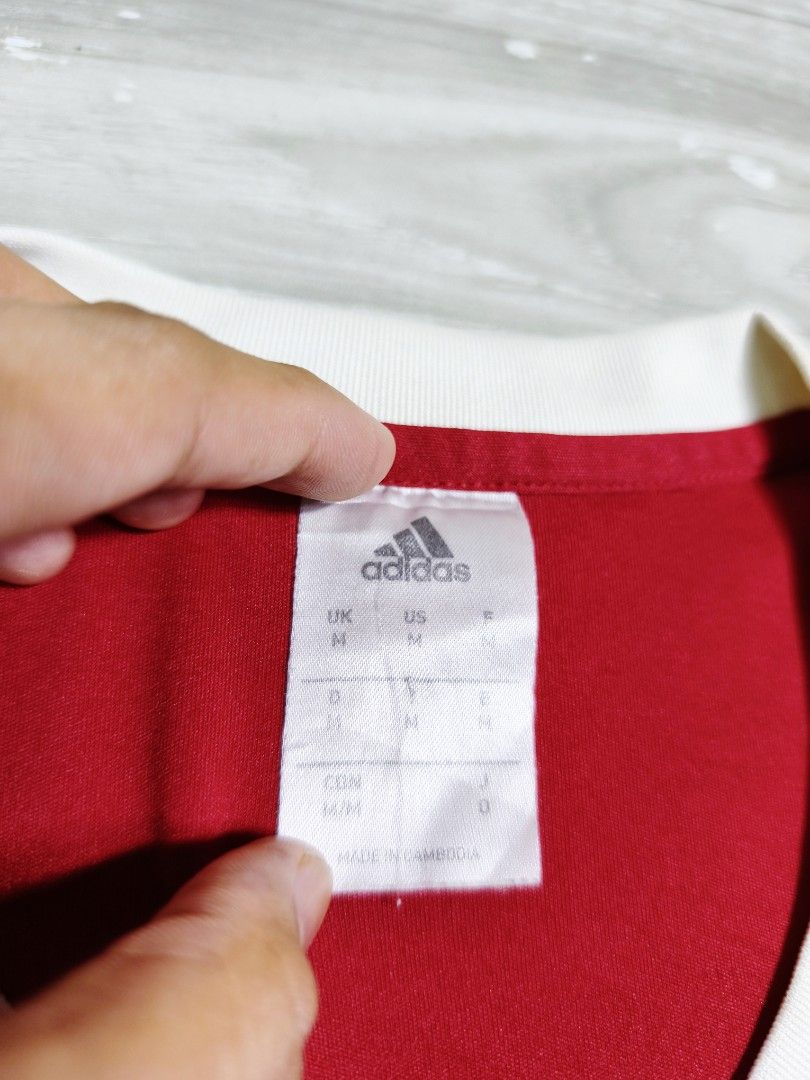 Adidas NVFC Football Jersey (Category: Activewear) located in Paranaque City. Submitted by pickersform (Listing ID 1465704542, Image 3). Description: - Adidas NVFC Jersey - Size: Medium-Large dimes 22x29 - Details: NVFC chest crest, Amo Vino Distributors sponsor logo, and number 9 on the back - Material: Climalite fabric for moisture management - embroidered logos minor crack on white print and minor lints only unnoticeable .