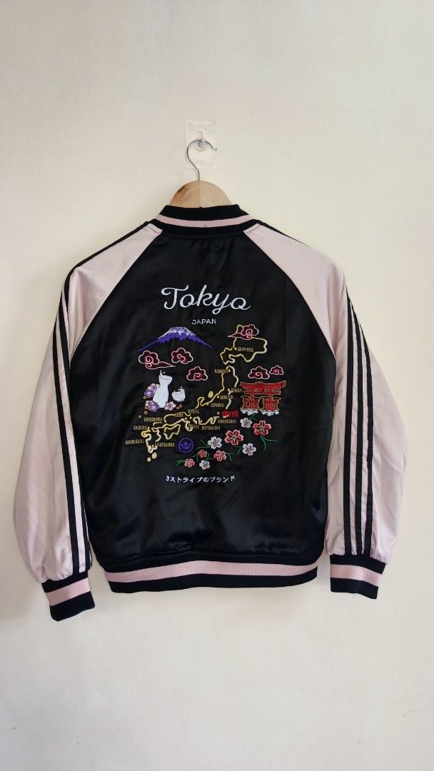 Adidas Reversible Tokyo Sukajan Bomber Jacket (Category: Coats, Jackets and Outerwear) located in Manila. Submitted by reysfindsph (Listing ID 1465733555, Image 2). Description: - Brand: Adidas Originals - Style: Reversible bomber jacket - Size: S (fits true) - Side A: Black satin with embroidered cranes on chest and Tokyo map on back - Side B: Dark blue textured fabric with crane embroidery - Features: Full zip closure, ribbed cuffs, side pocket