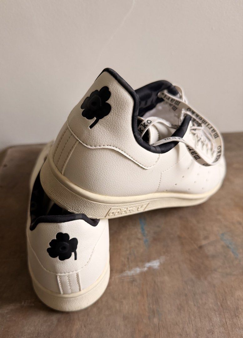 Adidas Stan Smith Marimekko White Black Sneakers (Category: Sneakers) located in Quezon City. Submitted by iwentrogue (Listing ID 1465620925, Image 3). Description: - Brand: Adidas x Marimekko Stan Smith - Size: US 11 / UK 10 / EUR 44 2/3 - Color: White leather upper with black details - Special Features: Distinctive Marimekko lettering laces, iconic floral poppy heel tab, and patterned inner lining - Inclusion: Original shoebox included - Condit