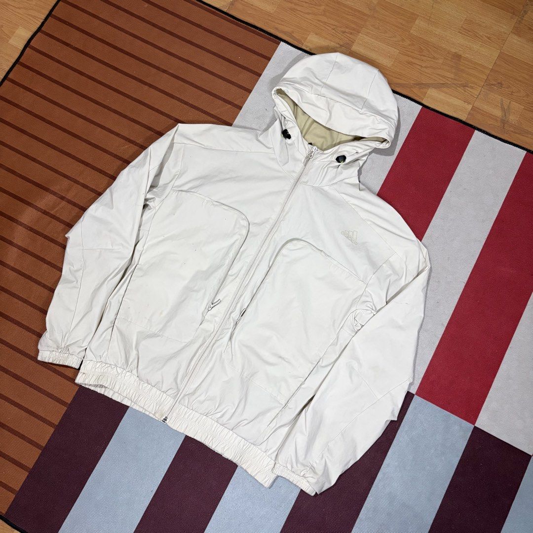 Adidas White Hooded Zip Jacket (Category: Coats, Jackets and Outerwear) located in Manila. Submitted by carlmachu (Listing ID 1465703708, Image 1). Description: - Brand: Adidas - Color: Off-white with subtle tonal logo - Size: L (Tag shown in photos) - Closure & Hood: Full front zipper with adjustable drawstring hood - Pockets: Large front utility pockets with secure zippered closures - Fit: Elasticated cuffs and hem for a snug fit - Note: Interi