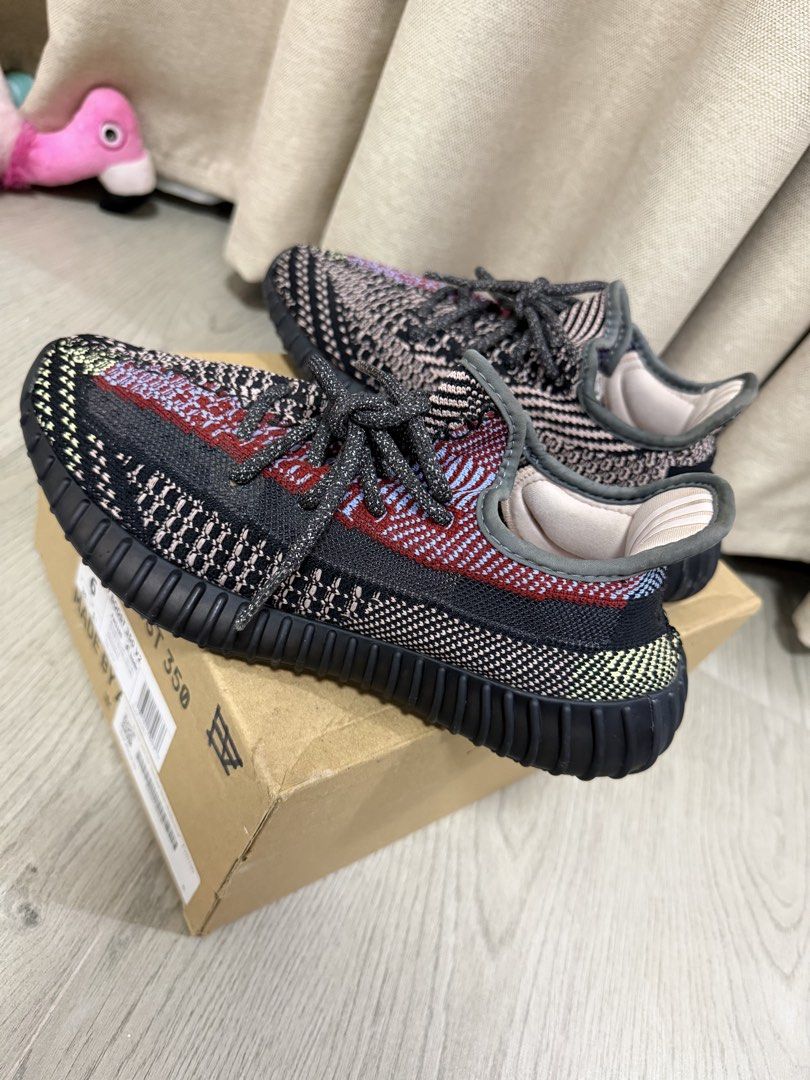 Adidas Yeezy Boost 350 V2 Yecheil Non-Reflective (Category: Sneakers) located in Manila. Submitted by chanelmari19 (Listing ID 1465755913, Image 2). Description: Adidas Yeezy Boost 350 V2 sneakers in the Yecheil colourway. Multi-coloured Primeknit upper combining black, red, blue, and yellow accents. Ribbed black midsole housing Boost cushioning. Includes original cardboard shoebox with size label showing US size 6. Dark reflective-style laces th