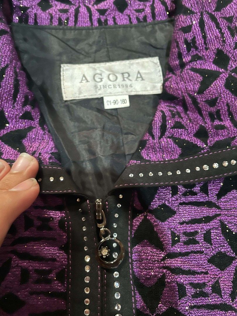 AGORA Purple Patterned Jacket with Rhinestones (Category: Coats, Jackets and Outerwear) located in Cagayan de Oro. Submitted by rhyrhyrhys (Listing ID 1465607681, Image 2). Description: - Brand: AGORA - Design: Purple and black patterned fabric with eye-catching rhinestone detailing on the zipper, collar, and pockets - Features: Full zip front, structured collar, two functional front pockets, and a fully lined interior - Size: Tag reads 91-96-160