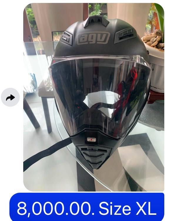AGV Motorcycle Helmet Size XL (Category: Caps & Hats) located in Pasig City. Submitted by cormatzu (Listing ID 1465655107, Image 1). Description: - Brand: AGV - Color: Matte Black - Size: XL - Visor: Large clear visor for wide visibility - Ventilation: Multiple ports on top and chin for steady airflow - Closure: Secure chin strap attached - Condition: Solid protection, perfect for daily rides.