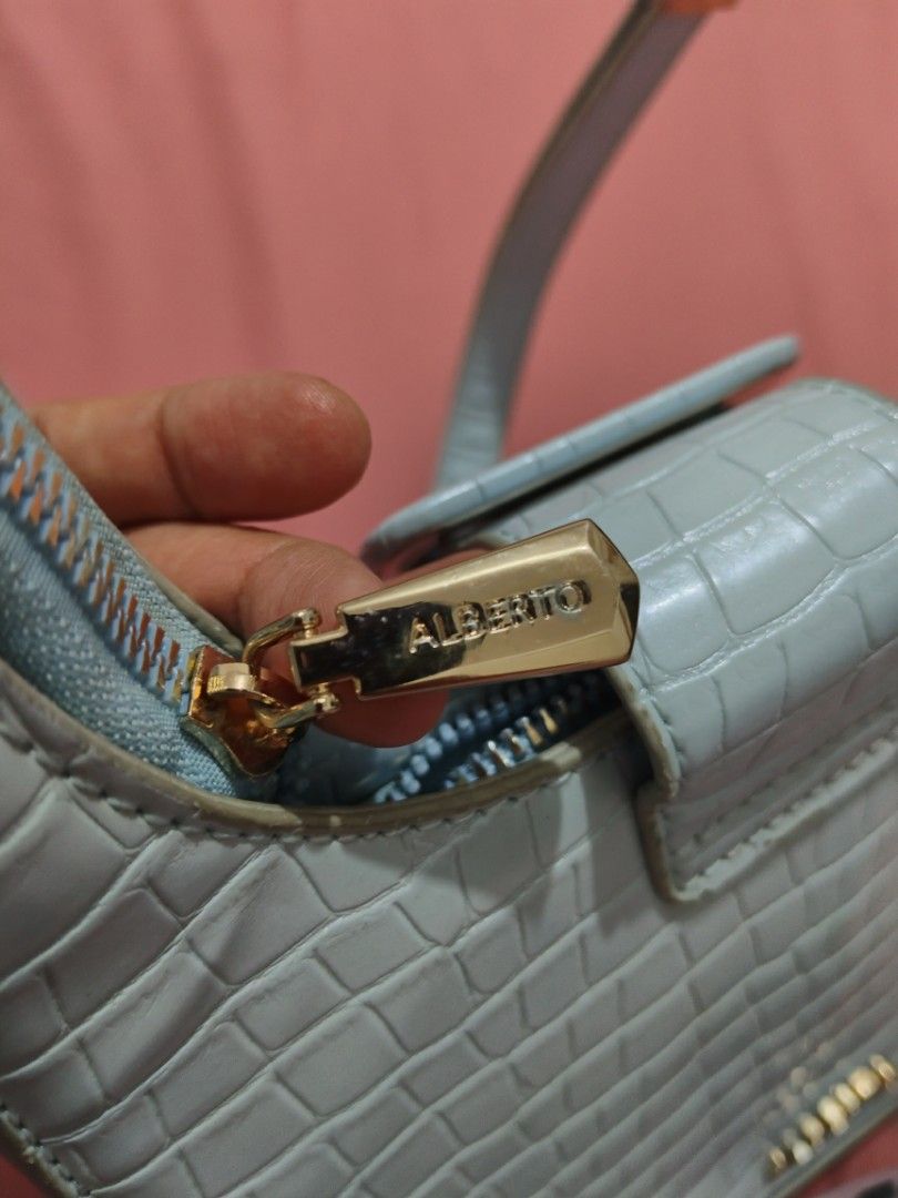 ALBERTO Light Blue Crocodile Embossed Shoulder Bag (Category: Shoulder Bags) located in Caloocan City. Submitted by karienina395238 (Listing ID 1465701341, Image 3). Description: NOT ukay. 2x ko lang nagamit. Its cute and handy. nakakabata🥰 - Brand: ALBERTO - Material: Light blue crocodile embossed leatherette - Hardware: Gold-tone - Closure: Top zipper with branded pull tab - Design: Structured shape with front buckle flap detail - Strap: Adjus