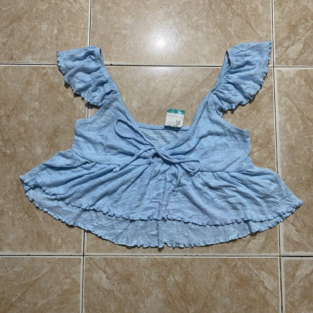 American Eagle Top (Category: Blouses) located in Manila. Submitted by killthismane (Listing ID 1465734483, Image 2). Description: American Eagle crop top features a cute front-tie detail and ruffled flutter sleeves.