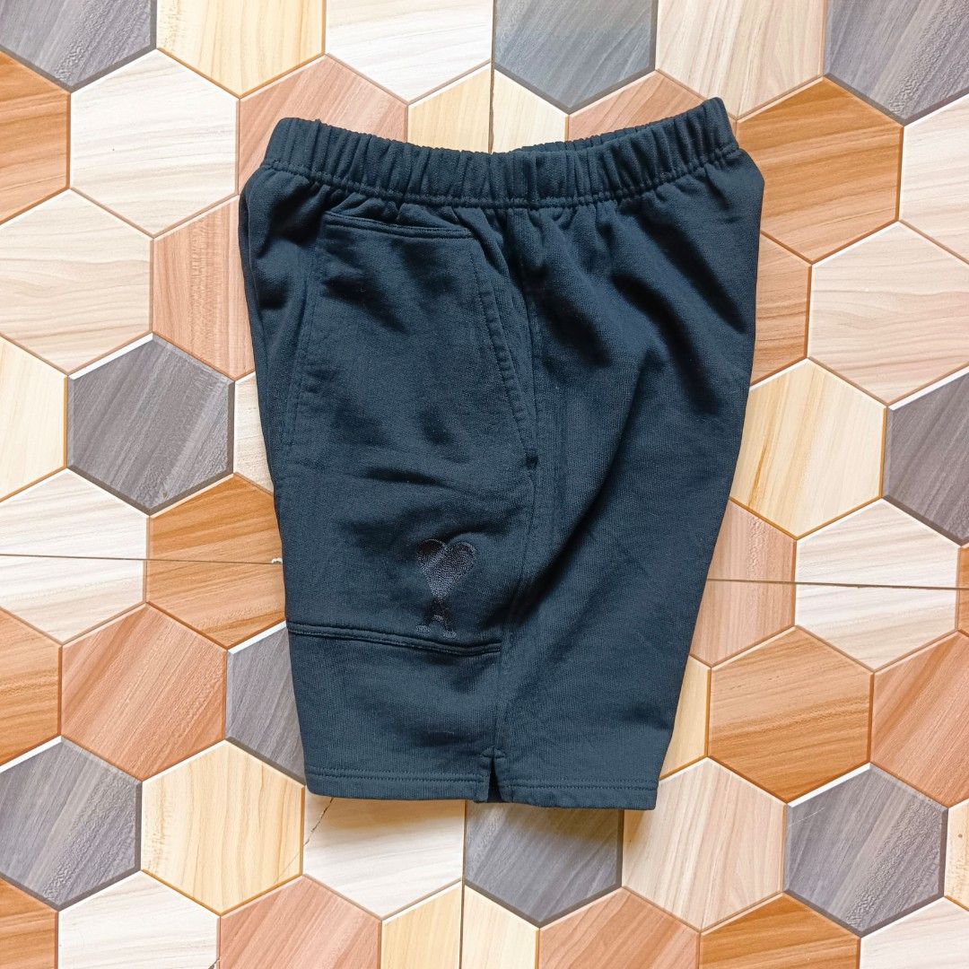 Ami Paris Black Shorts (Category: Shorts) located in Manila. Submitted by caps08 (Listing ID 1465745144, Image 1). Description: - Color: Solid dark black - Material: Soft French terry cotton inside - Waistband: Comfortable elastic waistband - Pockets: Functional slip pockets on both sides - Detail: Small embroidered heart logo on the lower left pocket - Quality: Clean stitching around the waist and hems - Condition: Brand new and ready to wear.