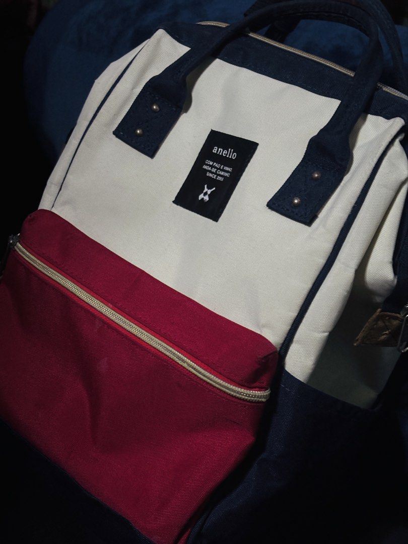 Anello Kuchigane Tri-Color Multi-Color Canvas Bag Backpack (Category: Backpacks) located in Pulilan. Submitted by shane_malik (Listing ID 1465623786, Image 1). Description: PRE-LOVED ANELLO BACKPACK bought last year, seldom used (negotiable) - Brand: Anello - Style: Canvas backpack in cream, navy blue, and red color block - Handles: Double top handles with snap button closure - Straps: Comfortable padded shoulder straps - Access: Handy back zip a