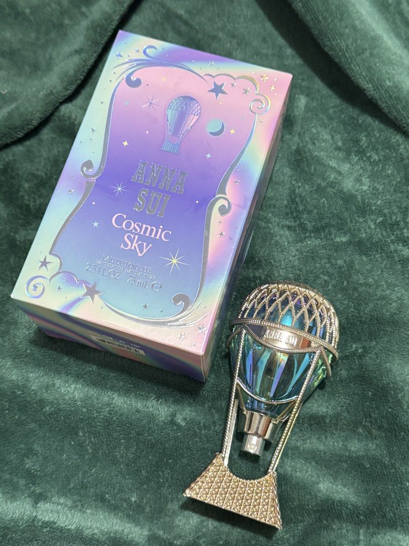 Anna Sui Cosmic Sky Eau De Toilette 75ml (Category: Fragrance & Deodorants) located in Marikina City. Submitted by virgo.bb (Listing ID 1465748563, Image 1). Description: - Authentic Anna Sui Cosmic Sky Eau de Toilette (75ml) - Stunning hot air balloon bottle design in iridescent blue and gold - Sweet and whimsical fragrance profile - Includes original holographic outer box - Spray nozzle is in perfect working condition - Well-kept and ready to s
