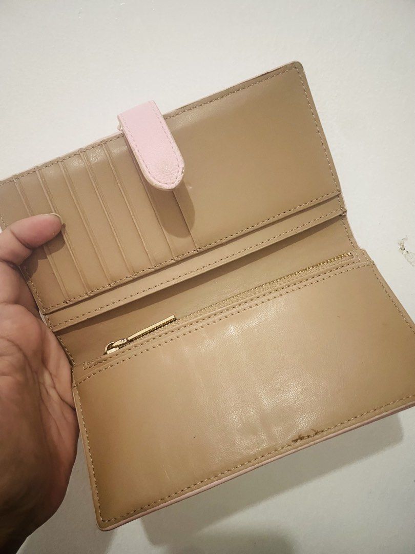 Anne Klein Pink Monogram Long Wallet With Removable Card Holder (Category: Wallets & Card holders) located in Antipolo. Submitted by emillauren (Listing ID 1465587971, Image 2). Description: - Brand: Anne Klein - Color: Pink with tan interior lining - Material/Design: Debossed AK monogram pattern with gold-tone metal lettering - Closure: Snap closure strap - Interior Features: Multiple card slots and a secure zippered compartment - Extras: Includ