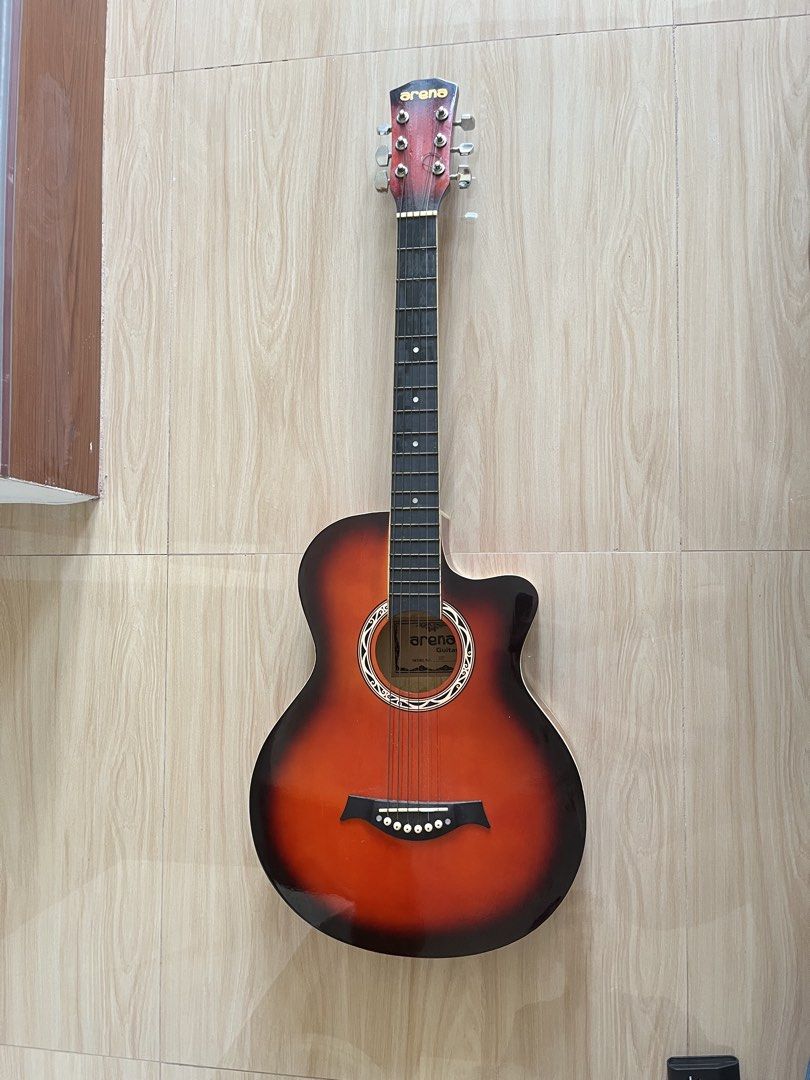 Arena 38C Acoustic Guitar (Category: Musical Instruments) located in Tanza. Submitted by morbita (Listing ID 1465594531, Image 1). Description: Arena 38C Jumbo Cut-Away Acoustic Guitar - Size: 38 Model: AG-38C - Too: Solid Basswood - Fingerboard : Rosewood - Bridge: Rosewood - Fret: 21 - Machine head: covered type - brown glossy finish - can do video condition upon request - guitar only and does not include other items - price still negotiable 🧧