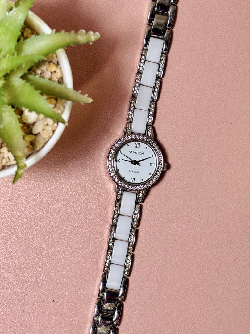 Armitron Ceramic Crystal Watch 75/3919SV (Category: Women's Watches) located in Sorsogon. Submitted by mascarinli36387 (Listing ID 1465587167, Image 3). Description: - Brand: Armitron (Model: 75/3919SV) - Color: White ceramic links with silver-tone hardware - Dial: Round with Roman numerals at 12, 3, 6, and 9 - Details: Bezel studded with sparkling clear crystals - Movement: Reliable Japan quartz with stainless steel case back - Fit: Slim bracele