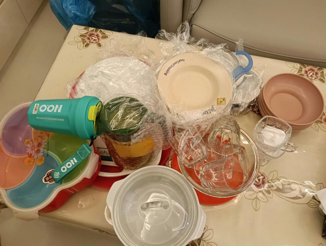 Assorted kitchenware and tableware bundle set (Category: Dinnerware & Cutlery) located in Singapore. Submitted by amrhayub (Listing ID 1465586171, Image 1). Description: Bundle of kitchenware and tableware items. Includes cups, bowls, plates, storage containers, and a teal water bottle with a strap. Mix of ceramic, glass, and plastic pieces. Some items still wrapped in original plastic. Great for setting up a new kitchen or replacing old tablewar