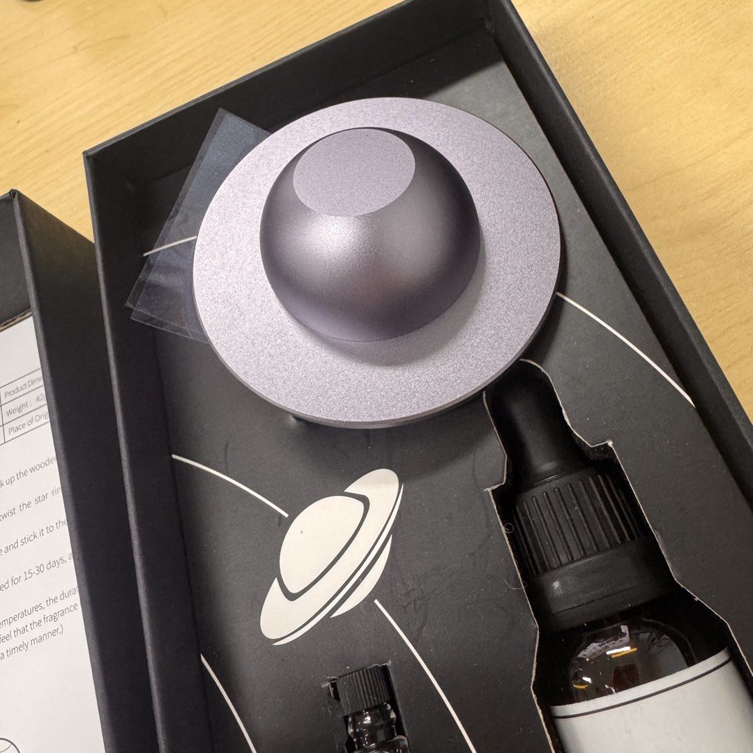 Asteroid Aroma Diffuser Santal Essential Oil Set (Category: Home Fragrance) located in Makati City. Submitted by sweethamshop (Listing ID 1465704350, Image 3). Description: - Item: Asteroid Aroma Diffuser Set (Black Box) - Condition: Unused / Brand New in Box - Inclusions: Wooden ball diffuser with metallic purple ring base, 10ml Santal essential oil, trial vial, and instruction manual - Perfect for: Gifting, room decor, or car freshener setup - 