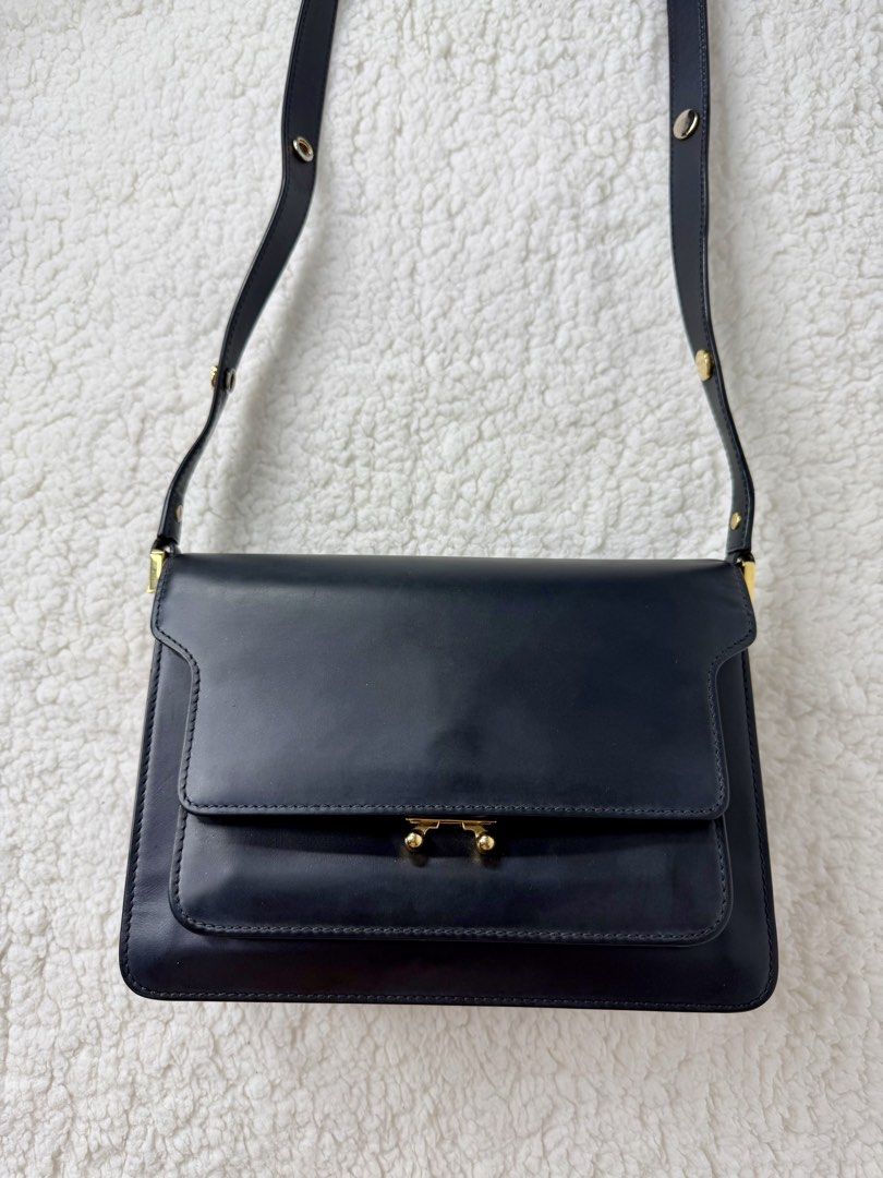 MARNI Trunk Medium Shoulder Leather Bag (Category: Luxury Bags & Wallets) located in Quezon City. Submitted by madame_bagelia_collection (Listing ID 1465668787, Image 2). Description: 🔸Authentic 💯 🔸Preloved 🔸Rank A (Almost New) 🔸Minimal scratches on metal lock 🔸Genuine leather 🔸Gold color hardwares 🔸Leather flap closure 🔸3 compartments 🔸2 zip & 1 slip pockets 🔸Fully lined interior 🔸Adjustable leather strap 🔸Medium size 🔸Dimension (c