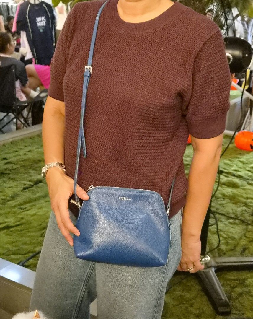 Authentic Furla Blue Crossbody Bag (Category: Cross-body Bags) located in Paranaque City. Submitted by regf_01 (Listing ID 1465666051, Image 1). Description: - Brand: Furla - Color: Blue - Material: Textured leather with silver-tone hardware - Style: Compact dome crossbody bag with top zipper closure - Strap: Adjustable thin strap - Interior: Clean lining - Condition: Excellent/Well-maintained/like new - Mode of Payment: GCash .