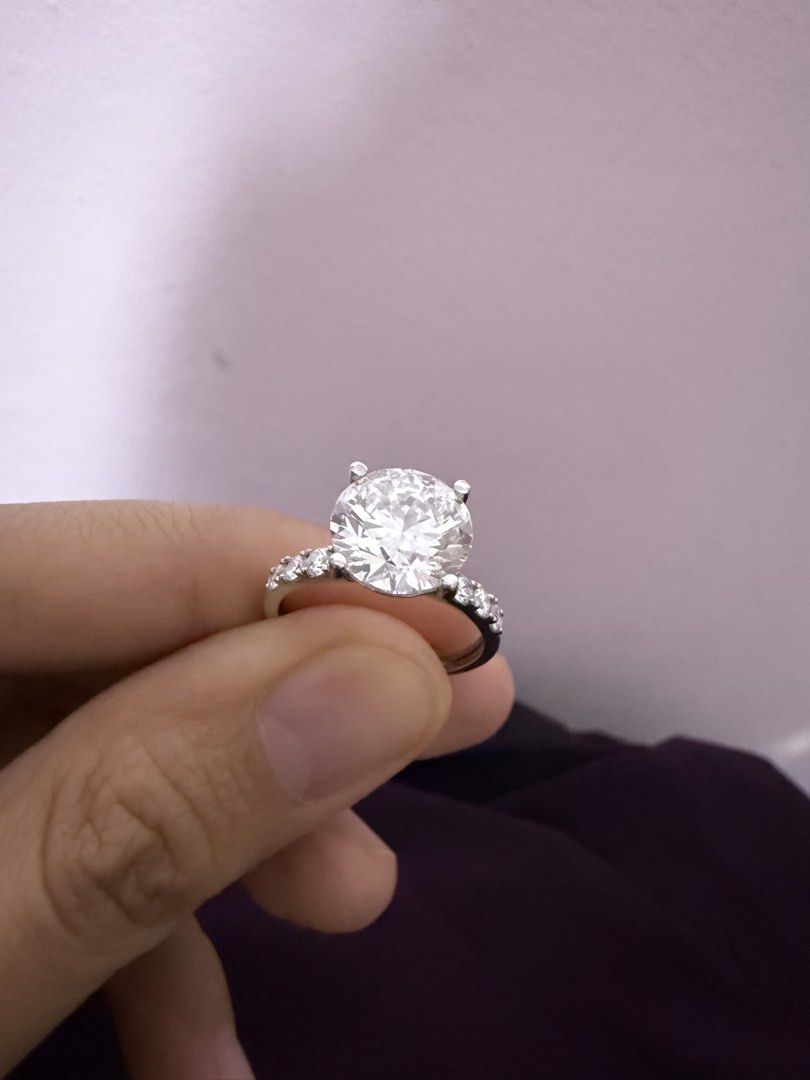 Authentic Solitaire 3.4carat Lab Grown Diamond Ring with Pave Band (Category: Rings) located in Manila. Submitted by mellow_sunday111 (Listing ID 1465616243, Image 1). Description: - Centerpiece: Brilliant-cut diamond with exceptional sparkle - Setting: Secure four-prong mount - Band: Elegant pavé-set stones on both sides - Metal Options: Available in white gold or platinum - Style: Traditional and timeless engagement look.