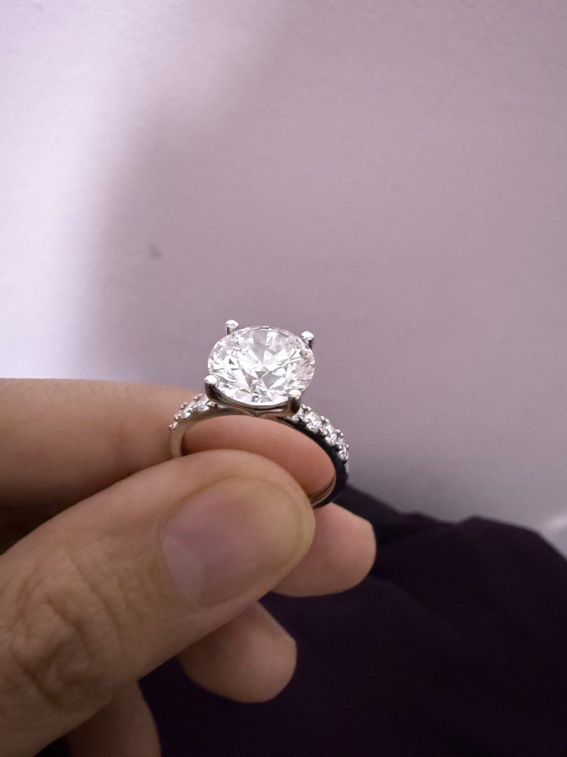 Authentic Solitaire 3.4carat Lab Grown Diamond Ring with Pave Band (Category: Rings) located in Manila. Submitted by mellow_sunday111 (Listing ID 1465616243, Image 2). Description: - Centerpiece: Brilliant-cut diamond with exceptional sparkle - Setting: Secure four-prong mount - Band: Elegant pavé-set stones on both sides - Metal Options: Available in white gold or platinum - Style: Traditional and timeless engagement look.