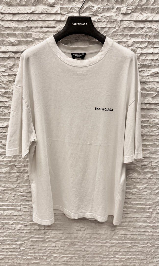 Balenciaga Back Logo T-Shirt (Category: Luxury Apparel) located in San Fernando. Submitted by mnlt_o (Listing ID 1465663013, Image 2). Description: One of Balenciaga's most recognizable, classic staples. Authentic ✅ Size: Medium (22.5" W × 29" L) Has a small pinhole on the left sleeve and lower-left back (both pictured), along with a fully faded care tag. Aside from these minor flaws, the shirt is in good pre-owned condition with no major stains 