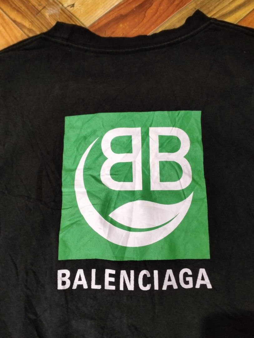 BALENCIAGA SHIRT (Category: Luxury Apparel) located in Solana. Submitted by allgoodst.s (Listing ID 1465715339, Image 3). Description: BALENCIAGA SHIRT large fitting 9/10 CR good condition black Balenciaga Eco Short Sleeve T-shirt featuring a green square graphic on the back with a white "BB" logo and a leaf symbol above the brand name Balenciaga..