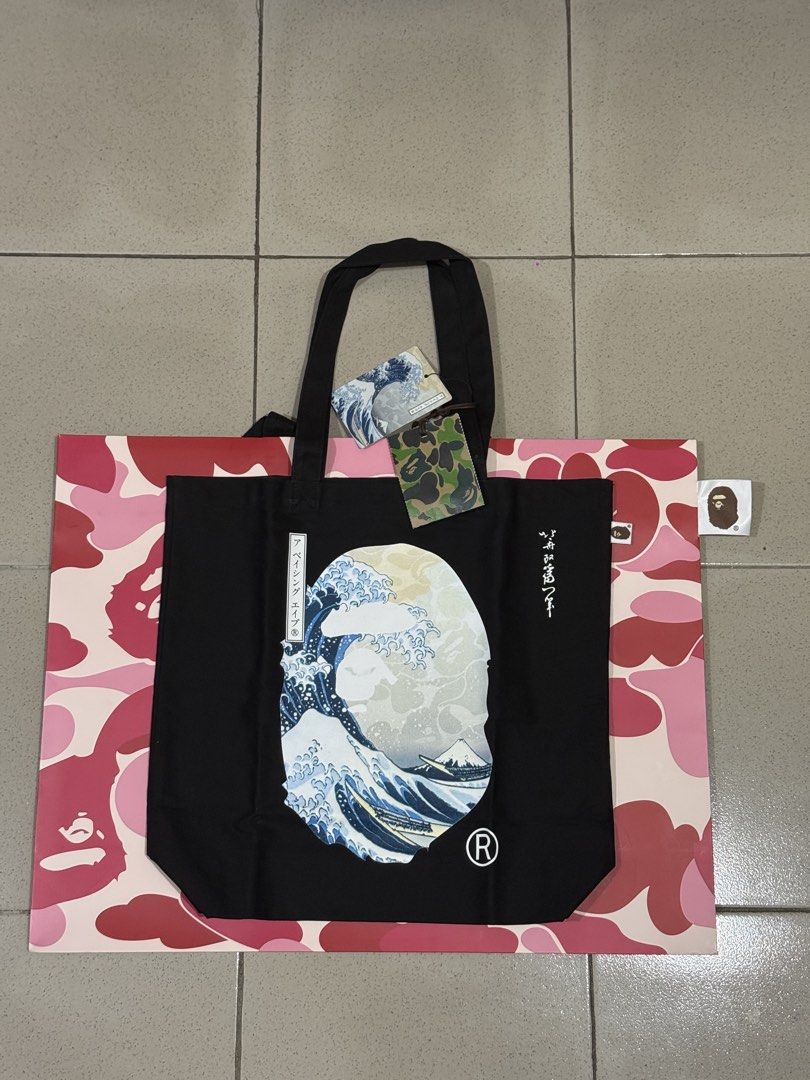 BAPE x Ukiyo-e Tote Bag (Category: Sling Bags) located in Quezon City. Submitted by juanalamat19 (Listing ID 1465610920, Image 1). Description: - Brand new, never used with original tags still attached - Iconic Great Wave Ape Head design with vertical Japanese text graphics - with receipt and paper bag (7,000PHP).