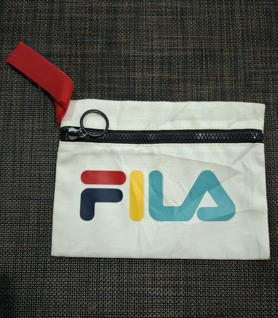Barbie and Fila Bundle (Category: Tote Bags) located in Don Carlos. Submitted by PphiXi_Finds (Listing ID 1465728374, Image 3). Description: - Barbie white small tote bag featuring yellow handles, colorful butterfly pattern, and a glitter logo on the front - Fila white zip pouch with multicolour logo branding and a convenient red pull loop - Condition: Both items are pre-owned - Ideal set for daily errands, casual outings, or as a handy everyday 