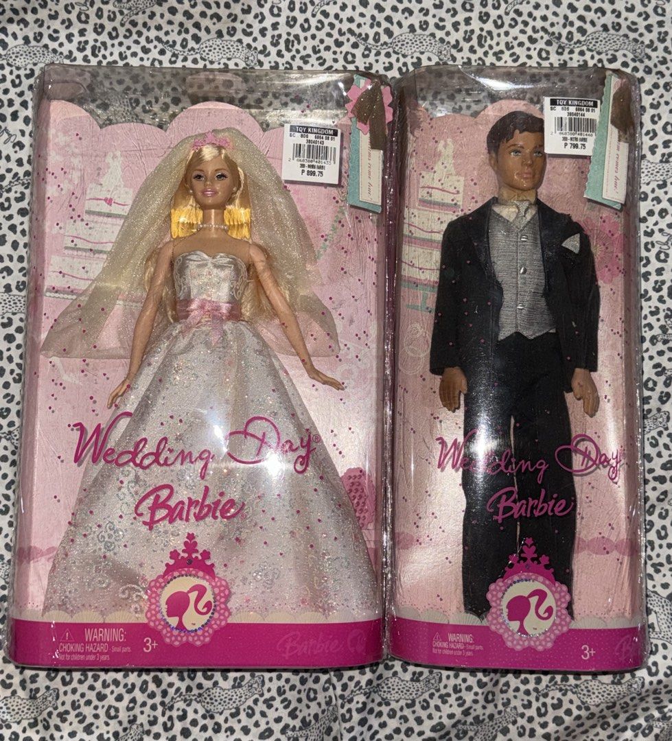 Barbie Wedding Day Set (Category: Kids Toys) located in Manila. Submitted by poporo.ly (Listing ID 1465597845, Image 1). Description: Wedding Day Barbie and Groom doll set. Bride wears a sparkly white gown with a pink ribbon waist, veil, and pearl necklace. Groom wears a black tuxedo with a grey patterned vest and matching tie. Both dolls stay sealed inside their original pink boxes..