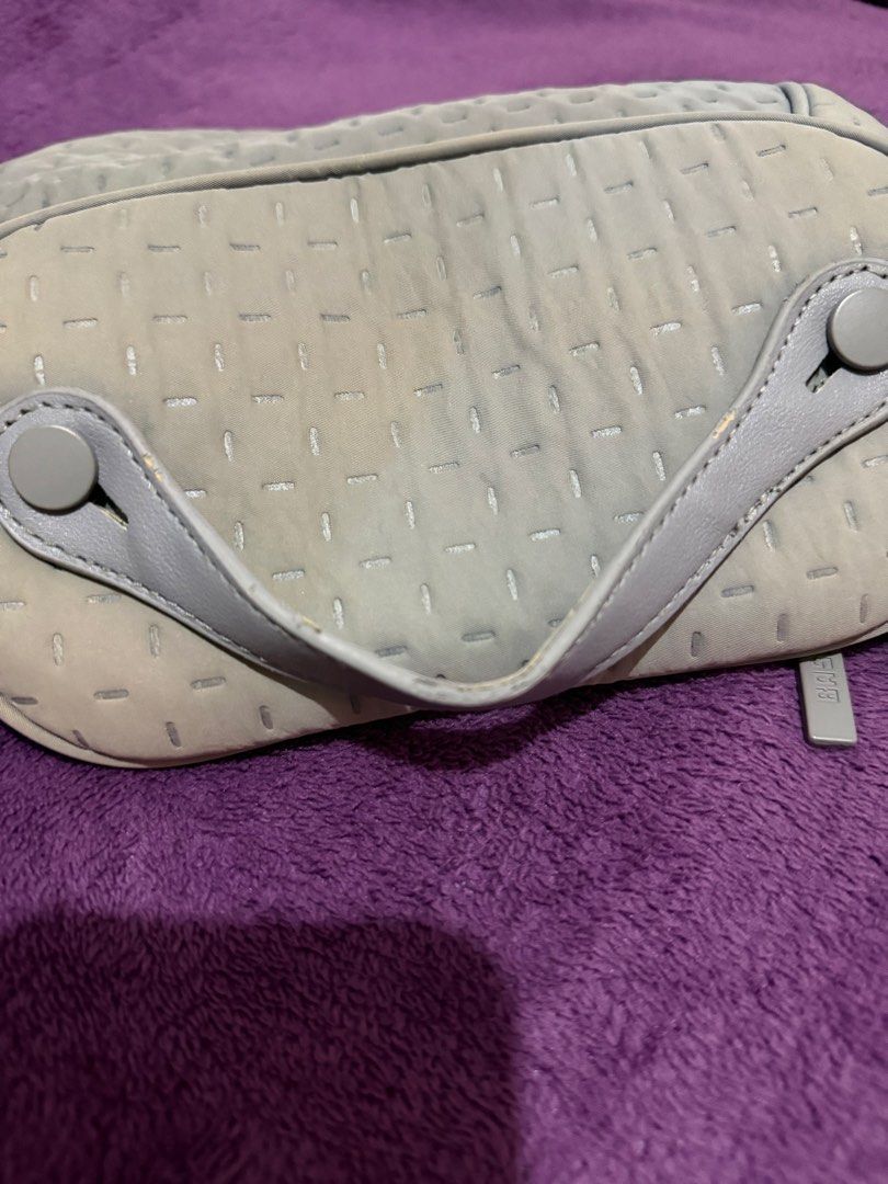 BASH BILLOW ORGANIZER IN STONE (Category: Purses & Pouches) located in Mandaluyong City. Submitted by merzypreloved (Listing ID 1465718395, Image 3). Description: - Brand: BASH - Color: Stone - Design: Chic quilted dash pattern all over with a structured shape - Closure: Wide-opening top zip for easy access - Organization: Built-in flap section featuring an elastic band and slip slots for makeup brushes - Portability: Convenient handle strap atta