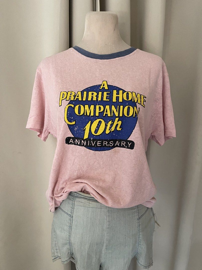 basic ringer tee (Category: Shirts) located in Cainta. Submitted by zlove111 (Listing ID 1465584314, Image 2). Description: - Vintage A Prairie Home Companion 10th anniversary t-shirt - Heather pink cotton fabric with contrasting blue ribbed collar - Large blue and yellow front graphic print - Short sleeves with a relaxed crew neck fit - Super soft, worn-in feel up to large .