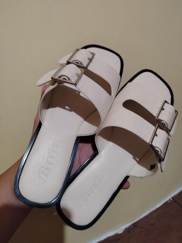 Bata cream double strap buckle slides (Category: Flats & Sandals) located in Caloocan City. Submitted by marco.antor (Listing ID 1465684138, Image 2). Description: - Brand: Bata - Color: Cream - Design: Double strap with metal buckles - Sole: Flat with a dark edge - Style: Easy slip-on for casual wear.