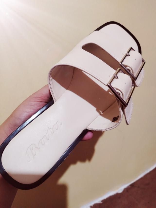 Bata cream double strap buckle slides (Category: Flats & Sandals) located in Caloocan City. Submitted by marco.antor (Listing ID 1465684138, Image 1). Description: - Brand: Bata - Color: Cream - Design: Double strap with metal buckles - Sole: Flat with a dark edge - Style: Easy slip-on for casual wear.