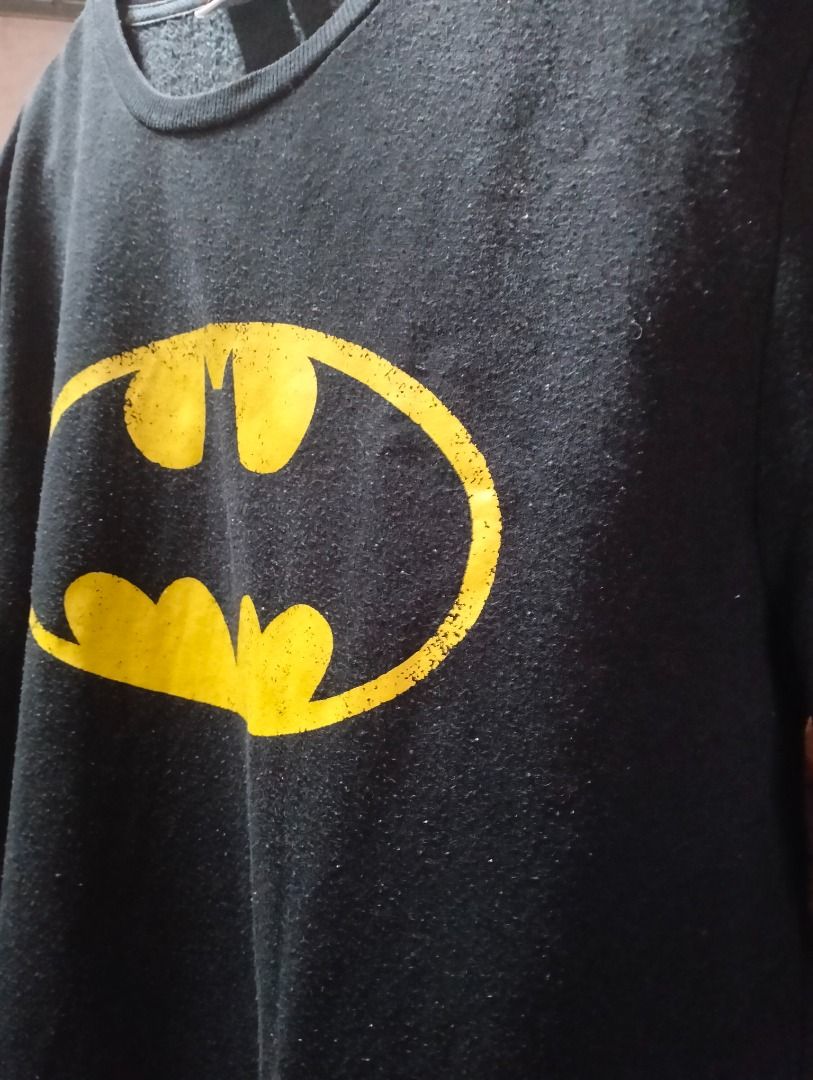 Batman Black Sweatshirt (SMALL) (Category: Coats, Jackets and Outerwear) located in Cavite. Submitted by brightfire.b90615 (Listing ID 1465635033, Image 2). Description: - Item: Black Batman sweatshirt with classic yellow logo - Neckline/Sleeves: Crew neck with long sleeves and ribbed cuffs - Size: Small (UK/IRL 10/12, EUR 38/40, USA 6/8, IT 42/44) - Condition: Pre-loved with visible pilling across the fabric - Style: Comfortable everyday pullove
