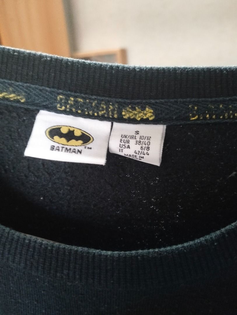 Batman Black Sweatshirt (SMALL) (Category: Coats, Jackets and Outerwear) located in Cavite. Submitted by brightfire.b90615 (Listing ID 1465635033, Image 3). Description: - Item: Black Batman sweatshirt with classic yellow logo - Neckline/Sleeves: Crew neck with long sleeves and ribbed cuffs - Size: Small (UK/IRL 10/12, EUR 38/40, USA 6/8, IT 42/44) - Condition: Pre-loved with visible pilling across the fabric - Style: Comfortable everyday pullove