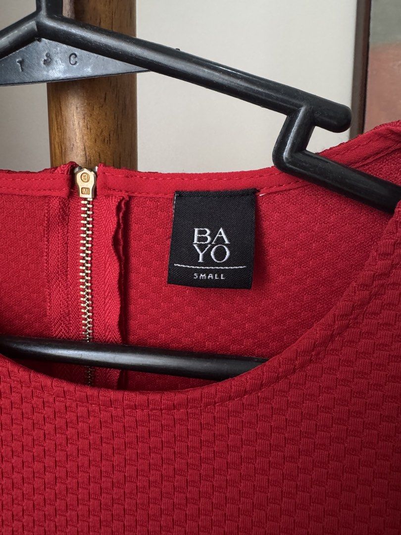 Bayo Red Textured Short Sleeve Top (Category: Blouses) located in Pasig City. Submitted by kutleyn (Listing ID 1465657669, Image 2). Description: - Brand: Bayo - Color: Red - Size: Small (tag attached) - Material: Textured fabric - Details: Round neckline with gold-tone back zipper - Style: Clean, simple cut ideal for casual days or work wear.