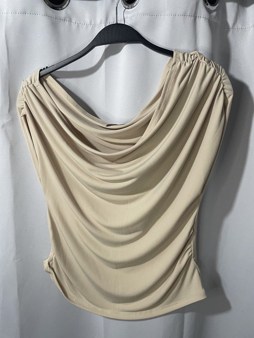 Beige Draped Cowl Neck Sleeveless Top (Category: Sleeveless) located in Bacoor. Submitted by prelovedbyphaty (Listing ID 1465583217, Image 1). Description: - Color: Versatile beige - Neckline: Elegant draped cowl neck - Details: Stylish ruched shoulders and gathered sides for a textured, fitted silhouette - Fit: Soft and stretchy fabric that flatters your shape - Hem: Trendy curved hemline.