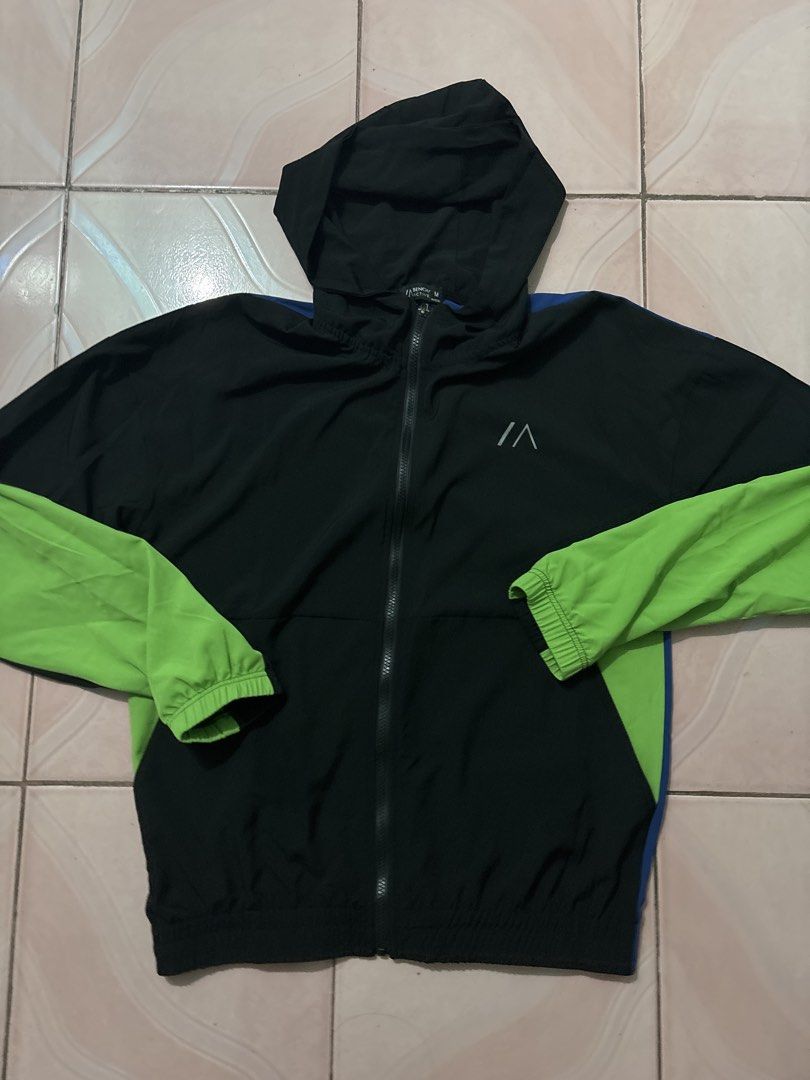 Bench Active Hoodie Jacket Black Green Blue Size M (Category: Coats, Jackets and Outerwear) located in Binan City. Submitted by fashion_claims (Listing ID 1465583362, Image 2). Description: - Brand/Model: Bench Active zip hoodie - Size: Men's Medium - Color: Black with bright green sleeves and blue accent panels - Features: Full front zipper, attached hood, elastic cuffs, hem, and chest logo print - Material: Lightweight fabric - Condition/Use: G