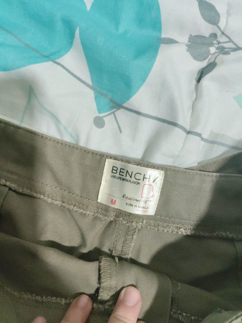 Bench olive green cargo shorts (Category: Shorts) located in Rizal. Submitted by anyadrea (Listing ID 1465667735, Image 2). Description: - Brand: Bench - Color: Olive green - Size: Medium (tag inside waistband) - Style: Casual everyday staple - Material: Simple cotton fabric - Features: Standard button and zip fly construction - Shipping: Ready for quick shipping.