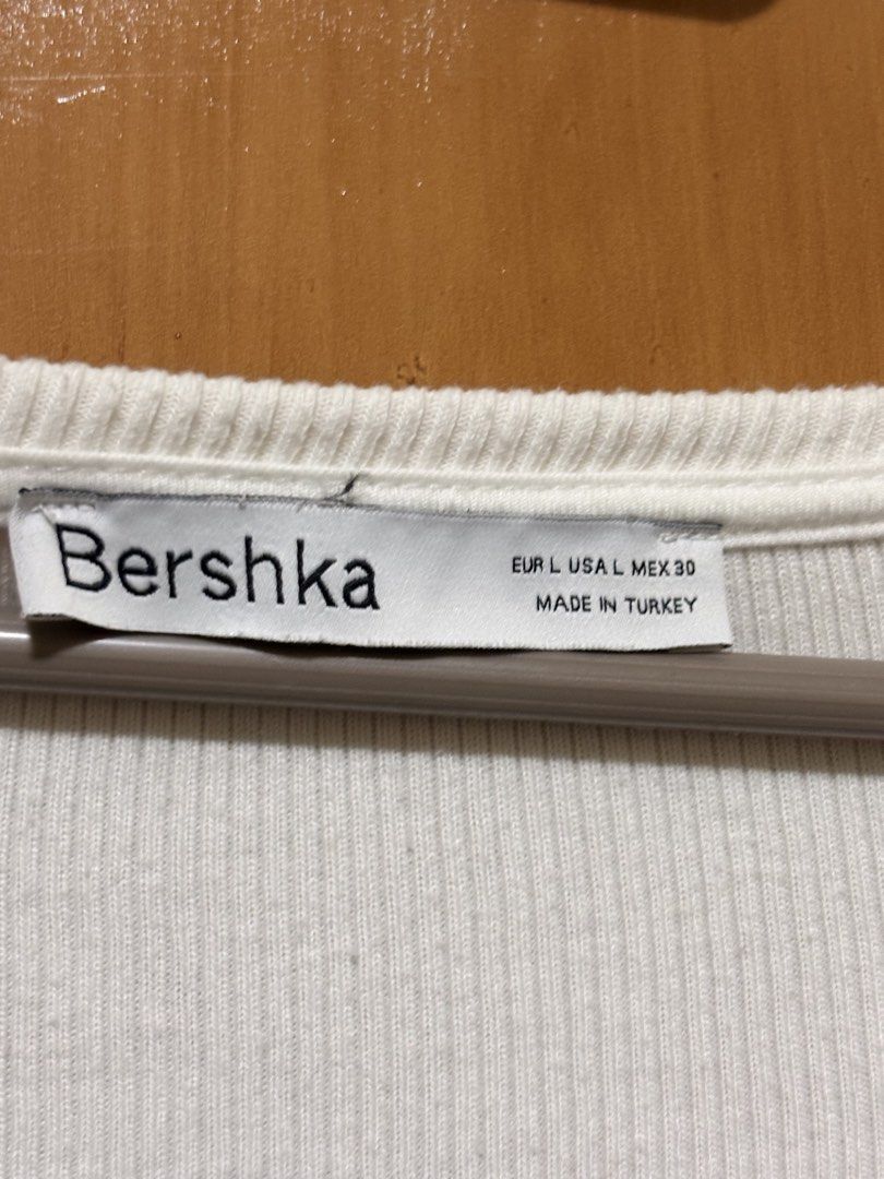Bershka Cardigan (Category: Longsleeves) located in Mandaue City. Submitted by klosetfindscebu (Listing ID 1465658237, Image 3). Description: - Brand: Bershka - Color: White - Size: L (EUR, USA, MEX) - Material: Ribbed knit, lightweight (Made in Turkey) - Style: Long sleeve crop top, deep V-neckline, front button closure, fitted silhouette.
