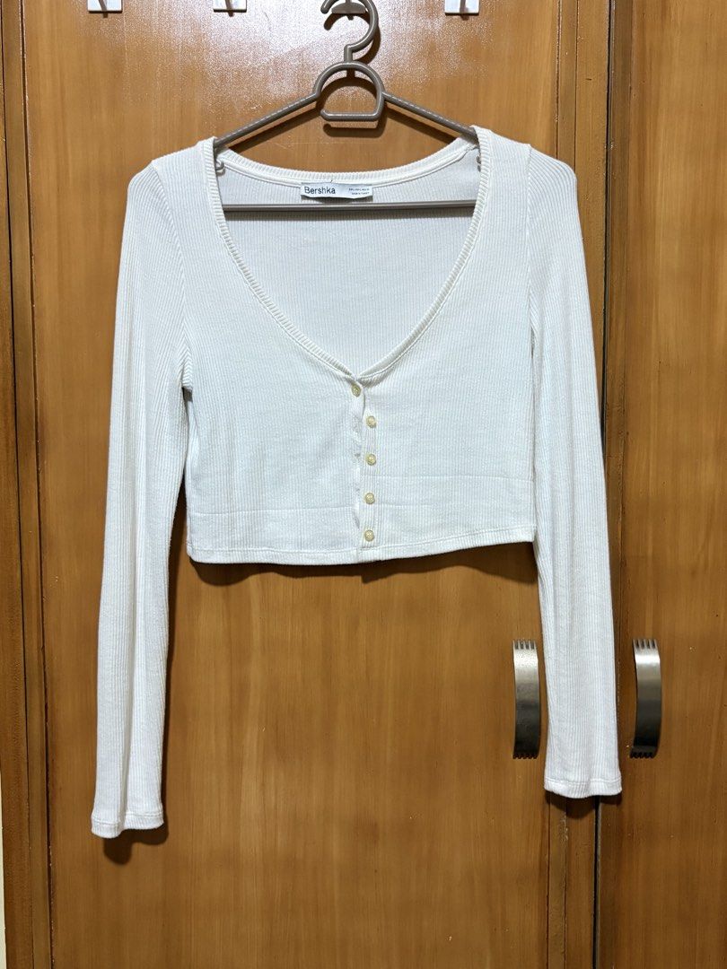 Bershka Cardigan (Category: Longsleeves) located in Mandaue City. Submitted by klosetfindscebu (Listing ID 1465658237, Image 1). Description: - Brand: Bershka - Color: White - Size: L (EUR, USA, MEX) - Material: Ribbed knit, lightweight (Made in Turkey) - Style: Long sleeve crop top, deep V-neckline, front button closure, fitted silhouette.