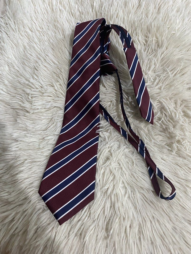 Biltmore Burgundy Striped Tie (Category: Ties) located in Bulacan. Submitted by rich2545 (Listing ID 1465581086, Image 1). Description: - Brand/Style: Biltmore classic tie in burgundy with navy and white diagonal stripes - Width: Standard width - Material: Clean fabric with a nice texture - Versatility: Ideal for formal wear, office work, weddings, and special events - Pairing: Easy to match with white or blue dress shirts.