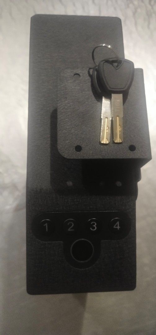 Biometric safe box with digital keypad and manual keys (Category: Safe) located in Muntinlupa City. Submitted by grayfox05 (Listing ID 1465710080, Image 1). Description: - Sleek black metal safe box in flawless, scratch-free condition - Advanced biometric fingerprint scanner and numbered keypad (1-4) - Versatile installation with a top mounting bracket and back panel screw slots - Includes 2 backup metal keys on a keyring - Ideal for securing cas