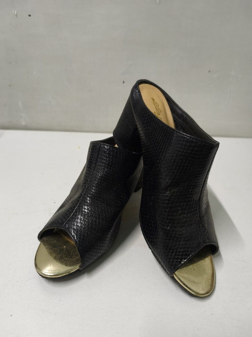 Black and gold open toe block heel mules (Category: Heels) located in San Jose del Monte. Submitted by missalipot (Listing ID 1465746731, Image 1). Description: - Style: Slip-on mules with open toes - Material: Black faux snakeskin with striking metallic gold toe caps - Heel: Comfortable chunky block heels for easy, all-day walking - Interior: Gold cushioned insole with printed logo - Condition: Minor wear on the gold toe tips from normal use - P