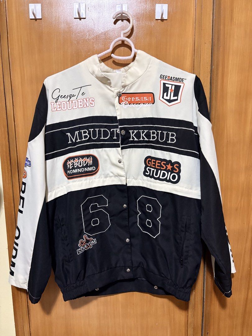 Black and White Graphic Racing Jacket (Category: Coats, Jackets and Outerwear) located in Mandaue City. Submitted by klosetfindscebu (Listing ID 1465658045, Image 1). Description: - Color: Black and white - Design: Multiple embroidered patches with '68' on front and '02' on back - Details: 'BOSNIAV' back lettering, vertical 'BELOIDM' arm prints, and stand-up collar - Fit: Oversized sleeves, snap button closure, and ribbed hem - Material: Comforta