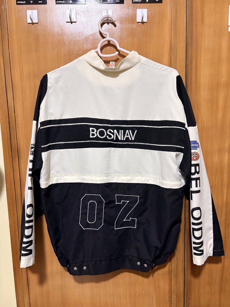 Black and White Graphic Racing Jacket (Category: Coats, Jackets and Outerwear) located in Mandaue City. Submitted by klosetfindscebu (Listing ID 1465658045, Image 2). Description: - Color: Black and white - Design: Multiple embroidered patches with '68' on front and '02' on back - Details: 'BOSNIAV' back lettering, vertical 'BELOIDM' arm prints, and stand-up collar - Fit: Oversized sleeves, snap button closure, and ribbed hem - Material: Comforta