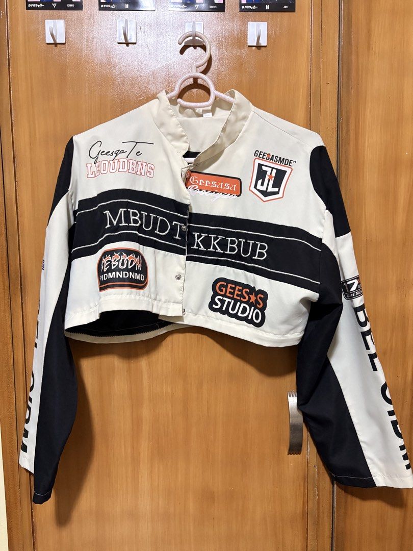 Black and White Graphic Racing Jacket (Category: Coats, Jackets and Outerwear) located in Mandaue City. Submitted by klosetfindscebu (Listing ID 1465658045, Image 3). Description: - Color: Black and white - Design: Multiple embroidered patches with '68' on front and '02' on back - Details: 'BOSNIAV' back lettering, vertical 'BELOIDM' arm prints, and stand-up collar - Fit: Oversized sleeves, snap button closure, and ribbed hem - Material: Comforta
