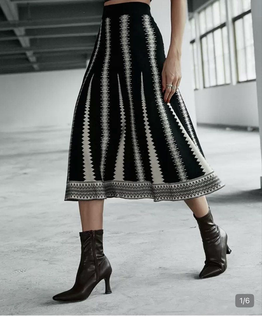 Black and White Knitted Midi Skirt Geometric Pattern (Category: Skirts) located in Pasig City. Submitted by jnzmrq1003 (Listing ID 1465581178, Image 1). Description: - Style: Mid-length knit skirt with black and white zig-zag pattern - Fit: Comfortable thick elastic waistband that holds its shape well - Material: Heavyweight knit fabric, perfect for cooler weather - Detail: Cute repeated diamond pattern border at the bottom hem.