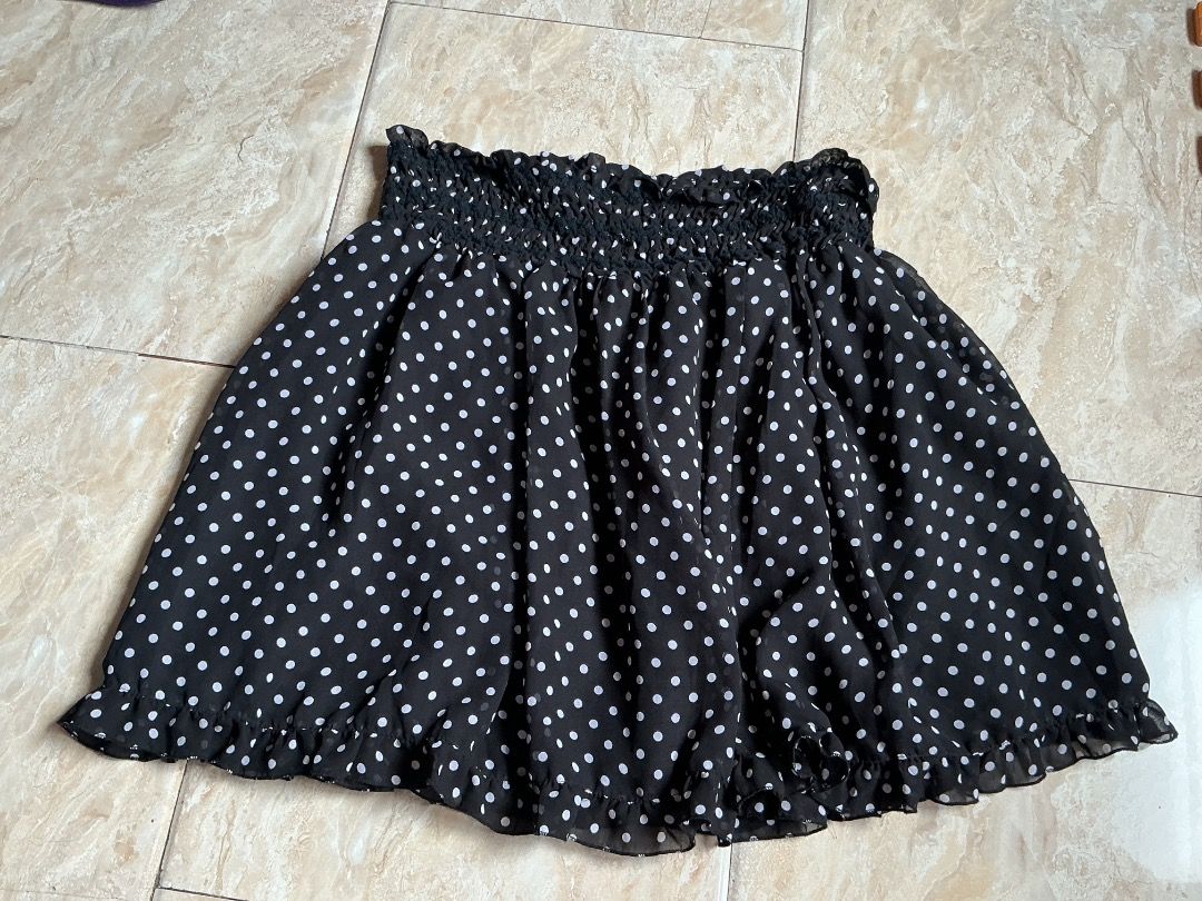 Black and White Polka Dot Ruffle Skirt (Category: Skirts) located in Valenzuela. Submitted by yve.aine (Listing ID 1465589193, Image 1). Description: - Style: Casual black skirt with tiny white polka dots - Waistband: Smocked elastic that stretches easily for comfort - Design: Flared silhouette with a cute ruffled hemline - Material: Lightweight chiffon-like fabric - Condition: Brand new / Excellent.