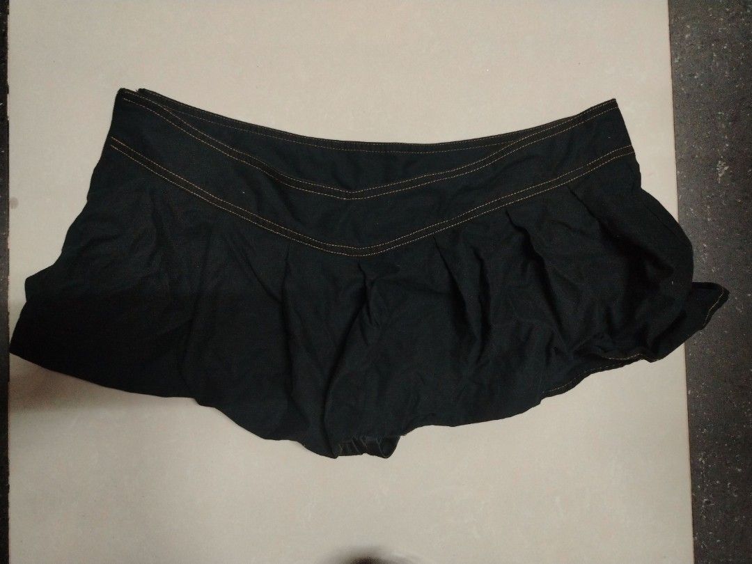 Black denim-style mini skirt with contrast stitching (Category: Skirts) located in Manila. Submitted by silver.springs (Listing ID 1465690227, Image 1). Description: - Color/Wash: Black denim in a dark wash - Design: Contrast orange stitching along the front yoke - Fit: Structured waistband with gathered body detail - Length: Mini / short - Closure: Secure fastening - Condition: Brand new / Excellent - with shorts.