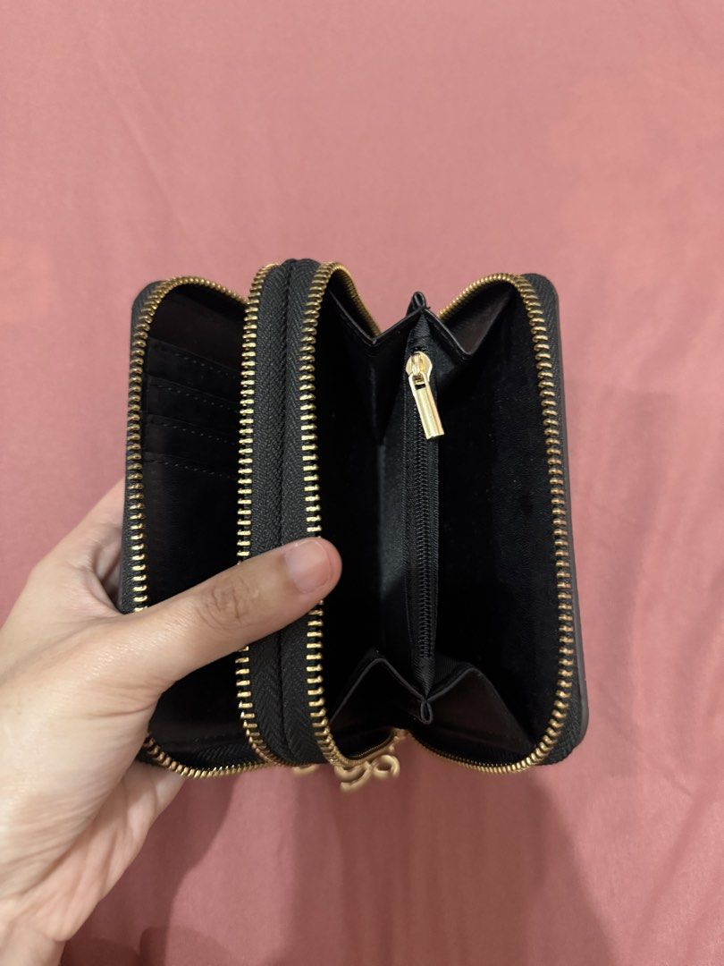 Black Double Zip Wallet with Gold Hardware (Category: Wallets & Card holders) located in Manila. Submitted by aaaine (Listing ID 1465755510, Image 2). Description: - Style: Black pebble-texture double-zip wallet - Accent: Unique gold-tone infinity metal logo on the front - Compartments: Double zip-around design with multiple card slots, slip pockets, and a central zippered coin pocket - Hardware: Premium gold-tone zippers and details - Size: Comp