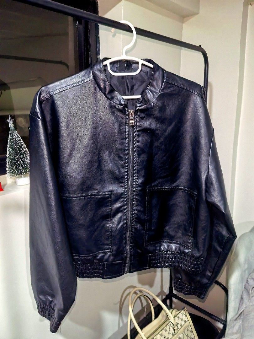 Black Faux Leather Bomber Jacket (Category: Coats, Jackets and Outerwear) located in Manila. Submitted by silentfish.7057b7 (Listing ID 1465744040, Image 1). Description: - Color/Material: Black faux leather - Closure: Front zipper - Fit: Snug ribbed hem and cuffs to keep shape - Pockets: Two roomy front pockets for essentials - Lining: Smooth inner lining for comfort - Best for: Cooler weather outerwear.